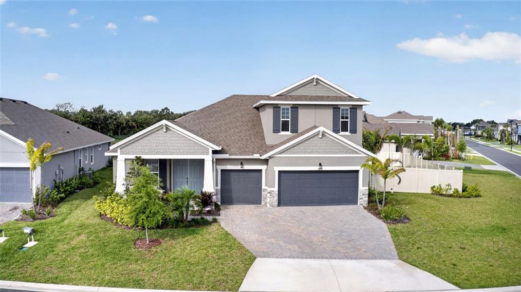 Front exterior of a new home in Seaire, Parrish, FL, highlighting curb appeal (Image 23).