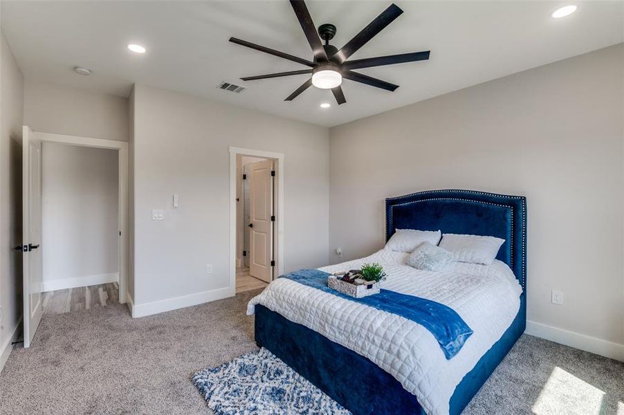 Carpeted bedroom with ceiling fan