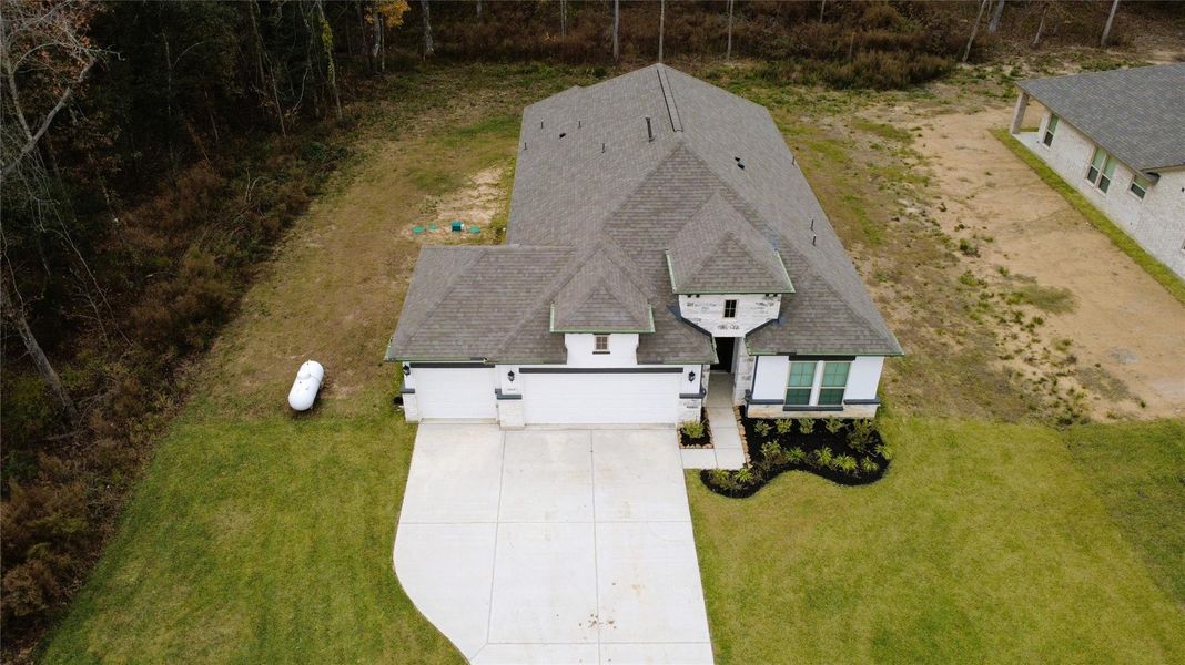 Front exterior of a new home in Encino Estates, Dayton, TX, highlighting curb appeal (Image 8).