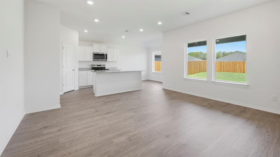 Unfurnished living room with recessed lighting and light wood-type flooring Unfurnished living room with recessed lighting and light wood-type flooring