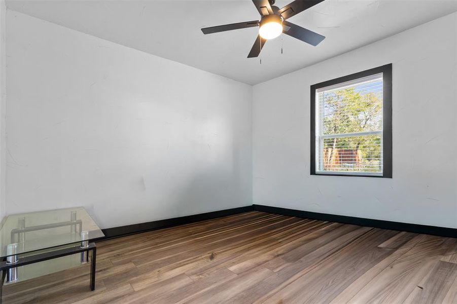 Spare room featuring wood finished floors and ceiling fan Spare room featuring wood finished floors and ceiling fan
