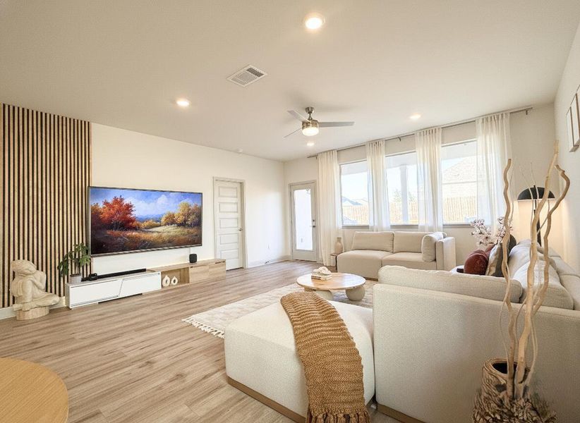 Living area with wood finished floors, recessed lighting, and a ceiling fan