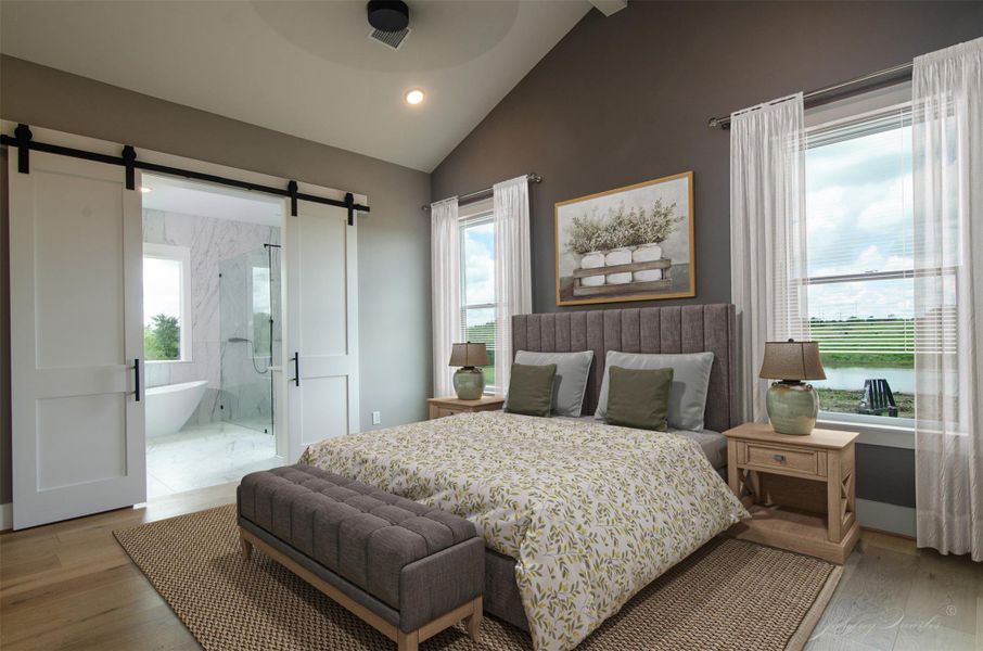 The spacious Primary Bedroom features a vaulted ceiling with barn doors to Ensuite The spacious Primary Bedroom features a vaulted ceiling with barn doors to Ensuite