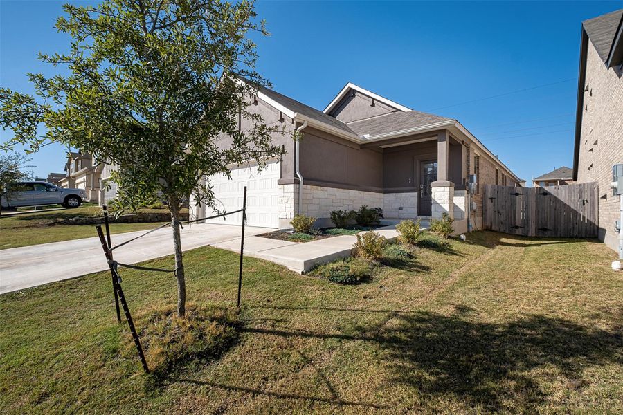 Front exterior of a new home in Sunfield, Buda, TX, highlighting curb appeal (Image 21).