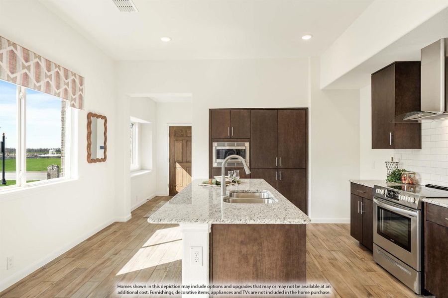Kitchen with granite island, dark wood cabinets, stainless steel appliances, and hardwood floors
