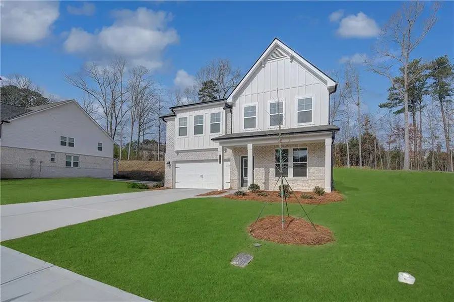 Front exterior of a new home in Hamilton Lakes, Lawrenceville, GA, highlighting curb appeal (Image 2). Front exterior of a new home in Hamilton Lakes, Lawrenceville, GA, highlighting curb appeal (Image 2).