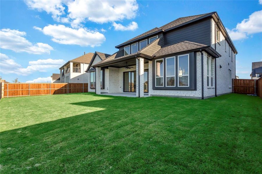 Back of house featuring brick siding, a ceiling fan, a patio, and a fenced backyard