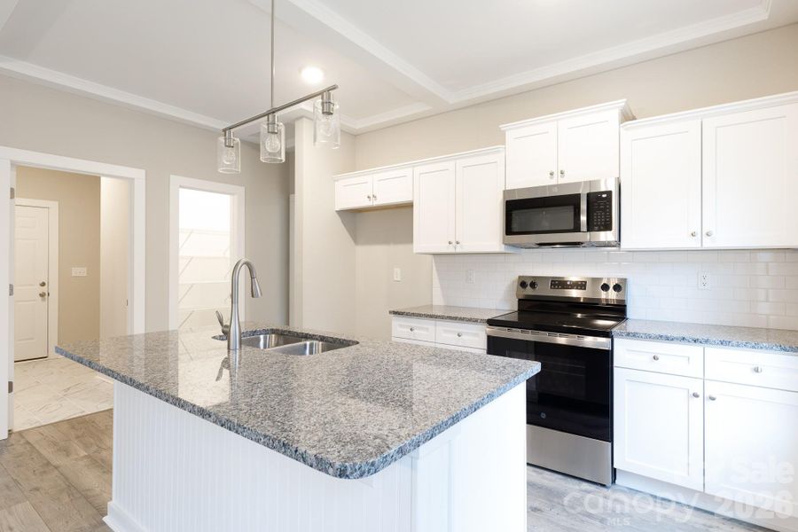 Laundry room to left leading to garage