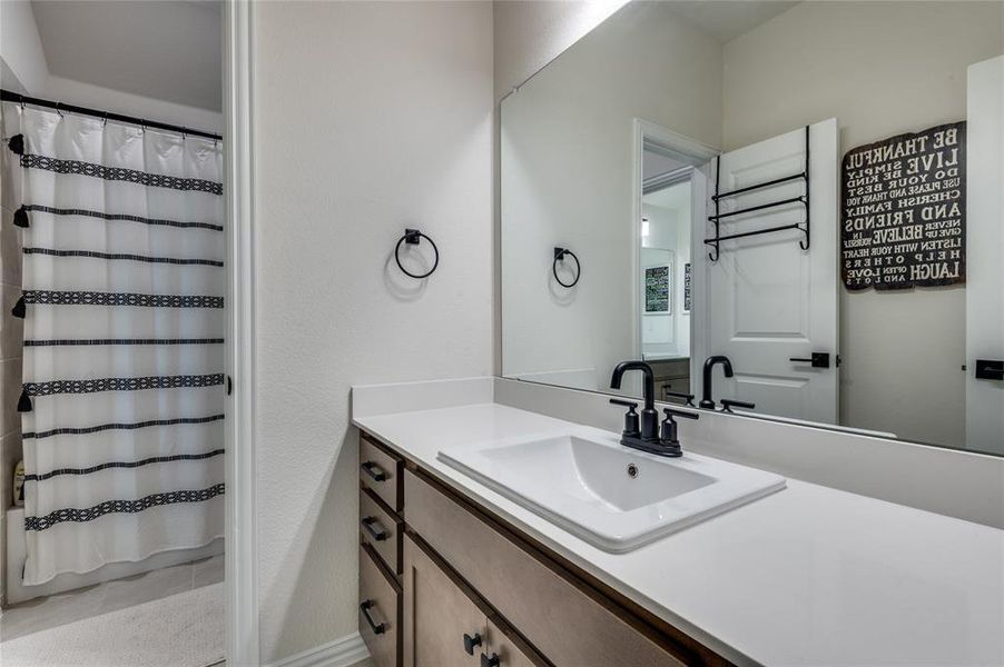 Full bathroom with vanity and shower / bathtub combination with curtain