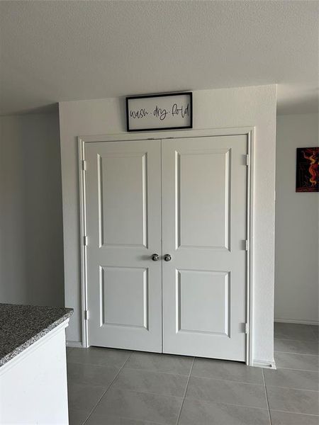 Room details featuring tile patterned flooring and a textured ceiling Room details featuring tile patterned flooring and a textured ceiling