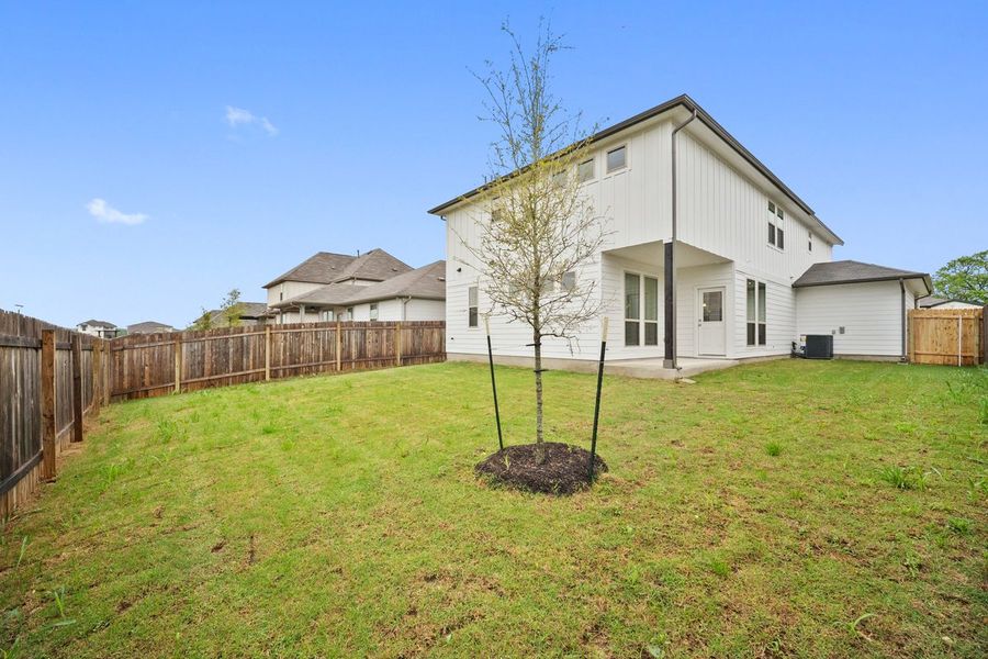 Front exterior of a new home in The Hills of Bear Creek, Manchaca, TX, highlighting curb appeal (Image 26).