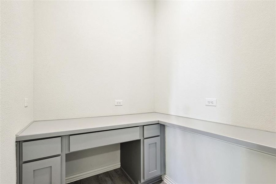 Unfurnished office featuring dark hardwood / wood-style floors