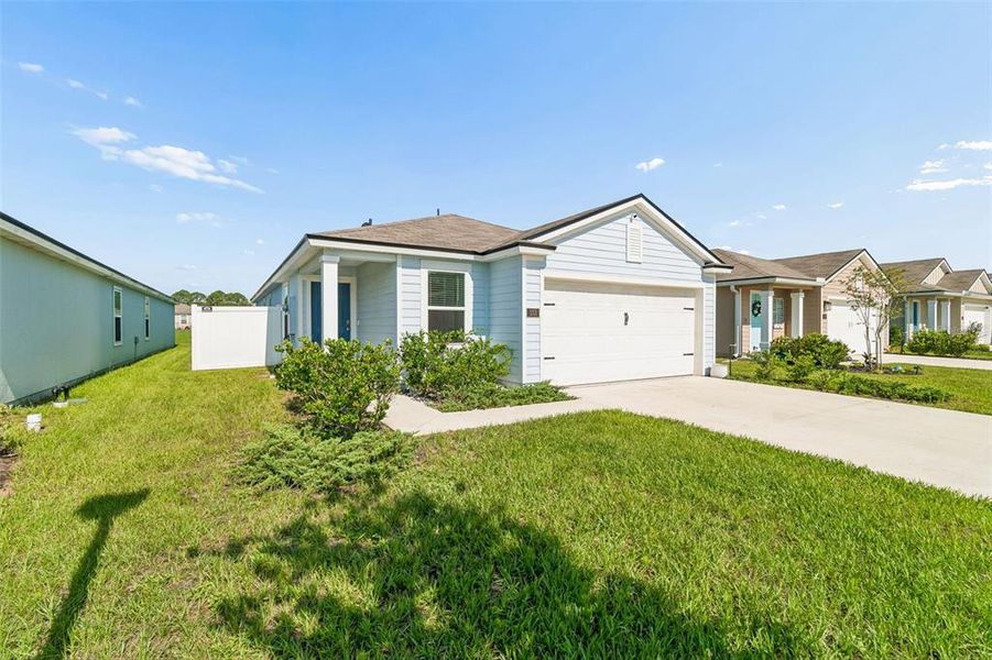 Front exterior of a new home in Ravenswood Village, St. Augustine, FL, highlighting curb appeal (Image 2). Front exterior of a new home in Ravenswood Village, St. Augustine, FL, highlighting curb appeal (Image 2).