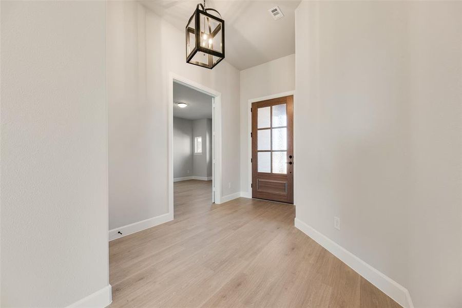 Entryway with a chandelier and light wood-style floors Entryway with a chandelier and light wood-style floors