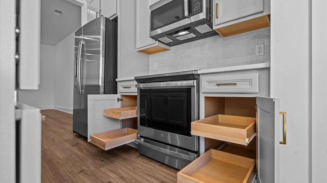 Tasteful design meets functional luxury in this kitchen with a 9-foot island and modern pendant lighting