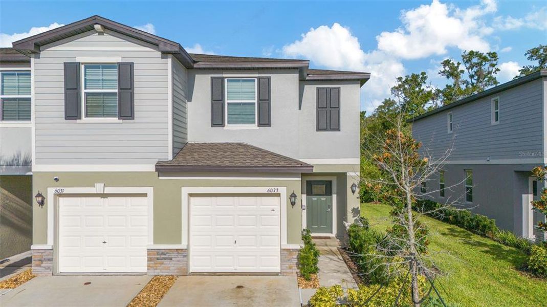 Front exterior of a new home in , Land O' Lakes, FL, highlighting curb appeal (Image 22).