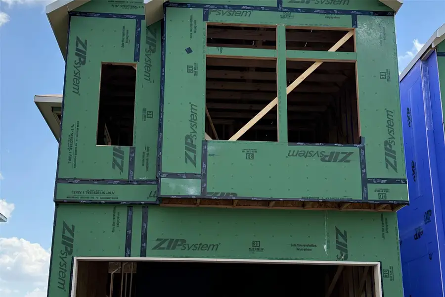 Progress updates reveal the sturdy wood framing and advanced sheathing of this new residence.