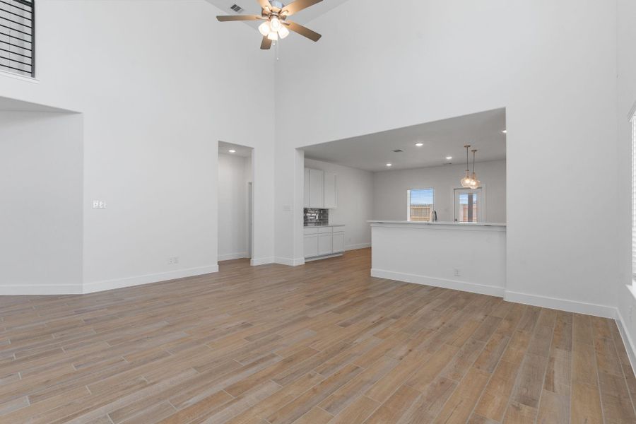 The soaring ceilings and open-concept design create a grand yet cozy feel. The family room effortlessly flows into the gourmet kitchen—ideal for gatherings both big and small. The soaring ceilings and open-concept design create a grand yet cozy feel. The family room effortlessly flows into the gourmet kitchen—ideal for gatherings both big and small.