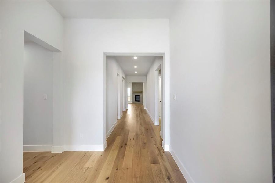 Hardwood-finish flooring extending through a broad hallway