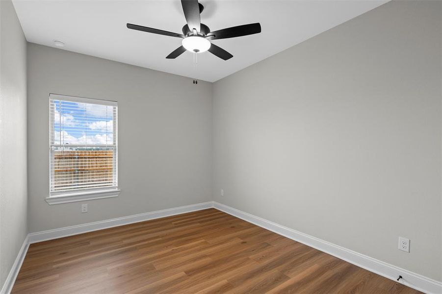Spare room featuring wood finished floors and ceiling fan Spare room featuring wood finished floors and ceiling fan