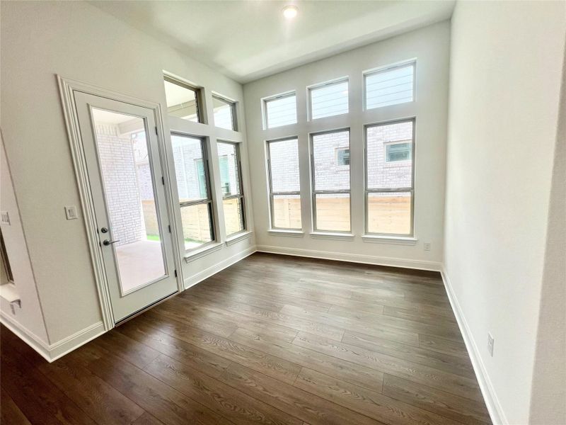 Doorway with plenty of natural light and dark wood finished floors Doorway with plenty of natural light and dark wood finished floors