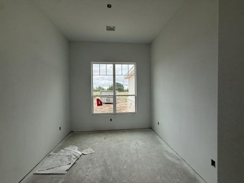 A window-filled room with clean lines, awaiting a personalized design.