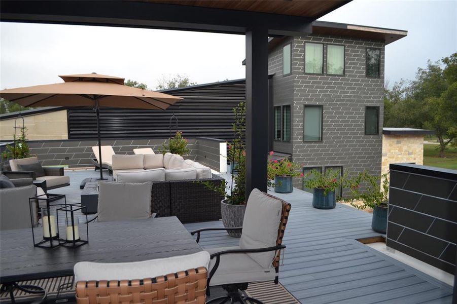 Deck featuring an outdoor living space and outdoor dining area Deck featuring an outdoor living space and outdoor dining area