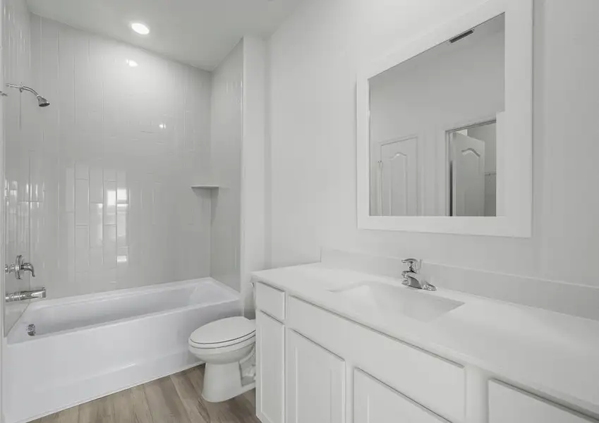 Tile detail surrounds the shower/tub combination in the secondary bathroom Tile detail surrounds the shower/tub combination in the secondary bathroom