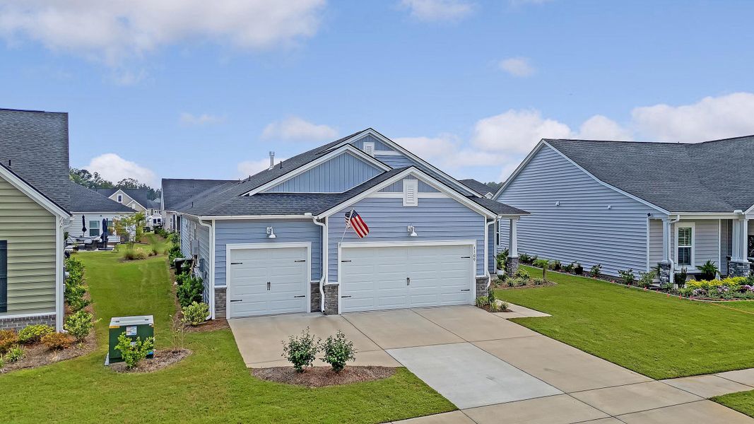 Front exterior of a new home in Horizons at Summers Corner | 55+: The Estates, Summerville, SC, highlighting curb appeal (Image 31).