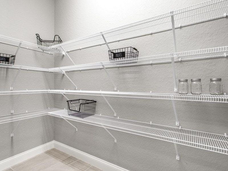 A large walk-in pantry offers storage for food and large kitchen appliances - Waylyn by Highland Homes