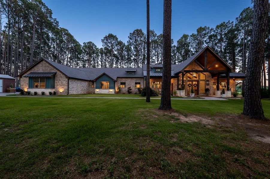 Custom home with every detail thought through sitting back on the 2acre lot full of pine trees.