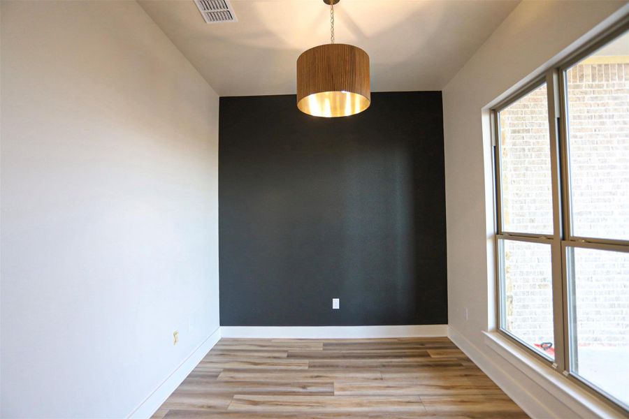 Spare room with light wood-style flooring and baseboards