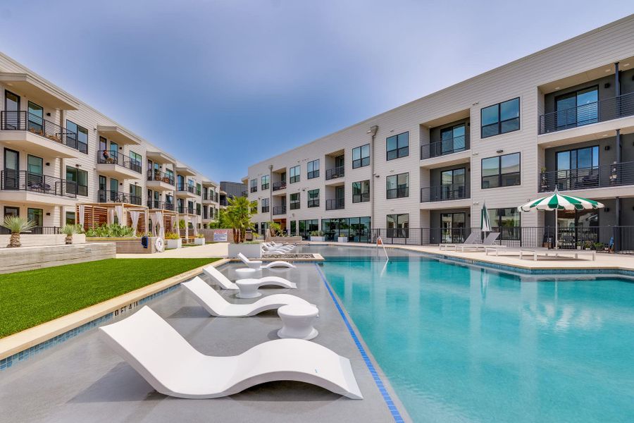 A bright and inviting swimming pool is at the center of this property, featuring integrated lounge chairs
