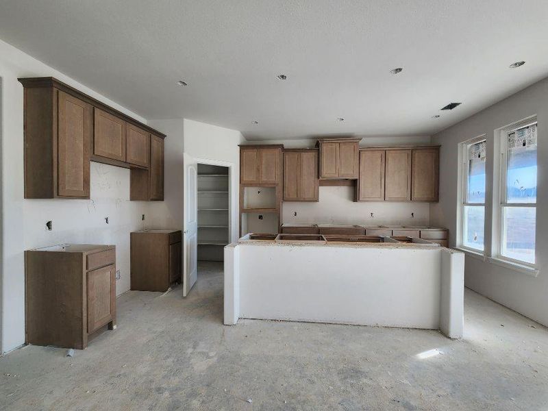 Kitchen with a center island and wood finish cabinetry