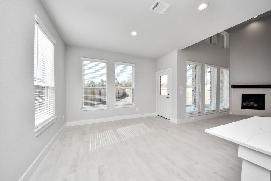 Enjoy breakfast with ease in the connected and cozy breakfast area, seamlessly integrated with the kitchen for utmost convenience. Step through the back door for a breath of fresh air onto the covered patio, extending your living space to the outdoors.