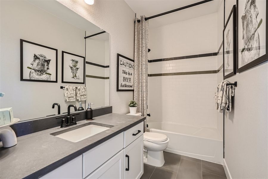 A bathroom with a sink toilet and a bathtub. A bathroom with a sink toilet and a bathtub.