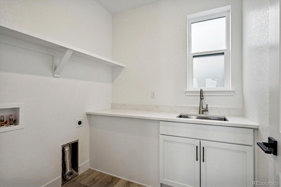 Upper level laundry for easy bedroom access; utility sink + storage cabinets & shelf Upper level laundry for easy bedroom access; utility sink + storage cabinets & shelf