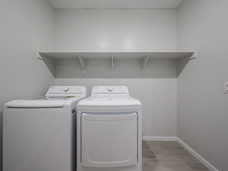 A washing machine and dryer in a room. A washing machine and dryer in a room.