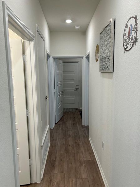 Hallway to secondary bedrooms, laundry room and garage. Hallway to secondary bedrooms, laundry room and garage.