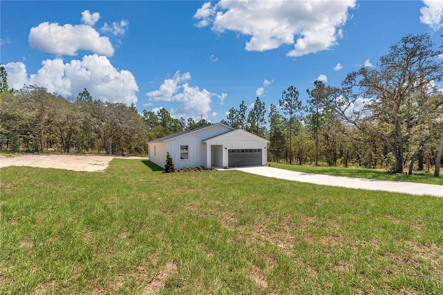 Front exterior of a new home in , Dunnellon, FL, highlighting curb appeal (Image 1).