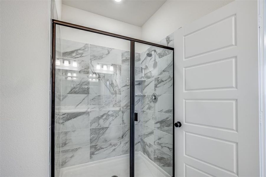 Bathroom featuring a shower stall Bathroom featuring a shower stall