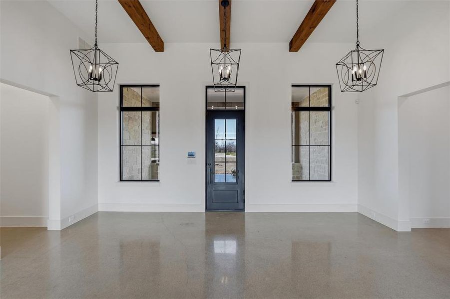 Foyer with suspended lighting and beamed ceiling Foyer with suspended lighting and beamed ceiling
