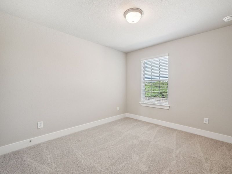 Guest bedroom in the Red River floorplan at a Meritage Homes community.