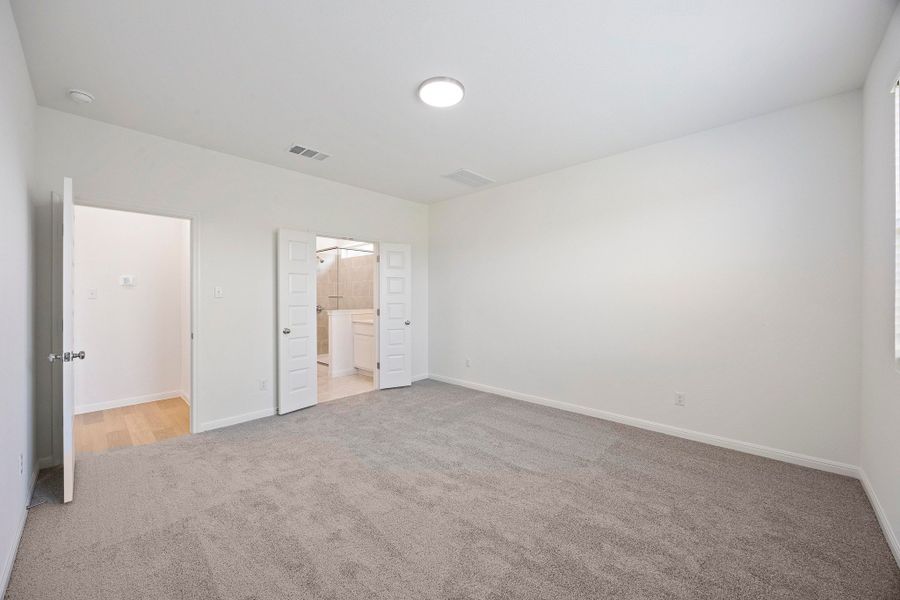 Primary Suite in the Magnolia home plan by Trophy Signature Homes – REPRESENTATIVE PHOTO