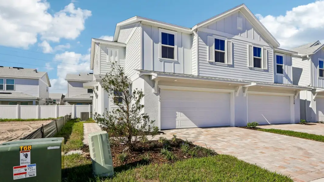 Front exterior of a new home in Cyrene at Harmony, St. Cloud, FL, highlighting curb appeal (Image 21). Front exterior of a new home in Cyrene at Harmony, St. Cloud, FL, highlighting curb appeal (Image 21).
