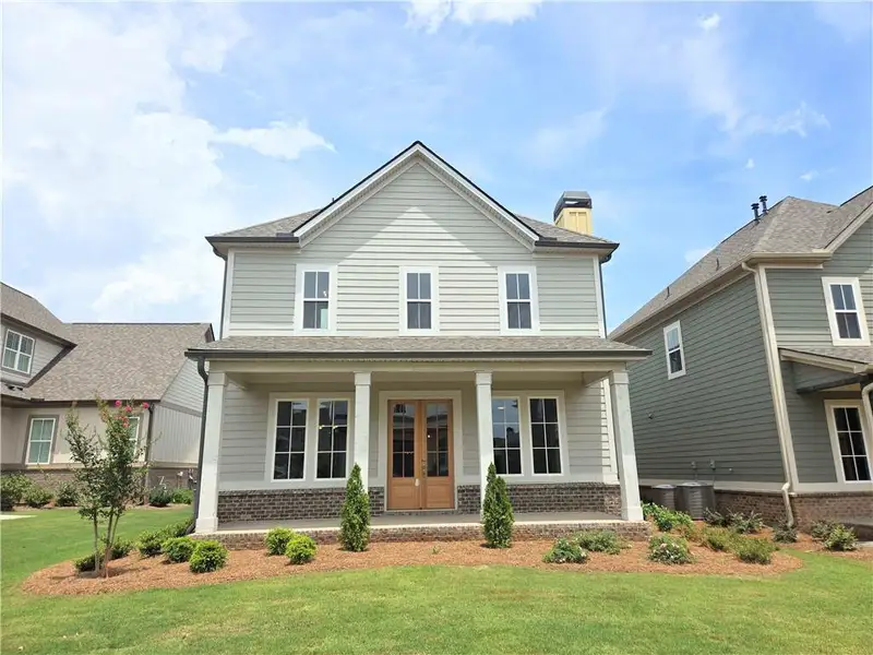 Front exterior of a new home in Trove, Watkinsville, GA, highlighting curb appeal (Image 1). Front exterior of a new home in Trove, Watkinsville, GA, highlighting curb appeal (Image 1).