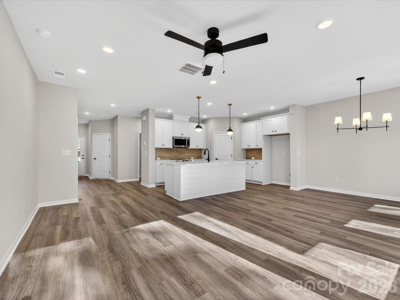 This open floor plan is filled with natural light - LVP flooring throughout the main level of the home. Large island with is wrapped in shiplap and quartz countertops.