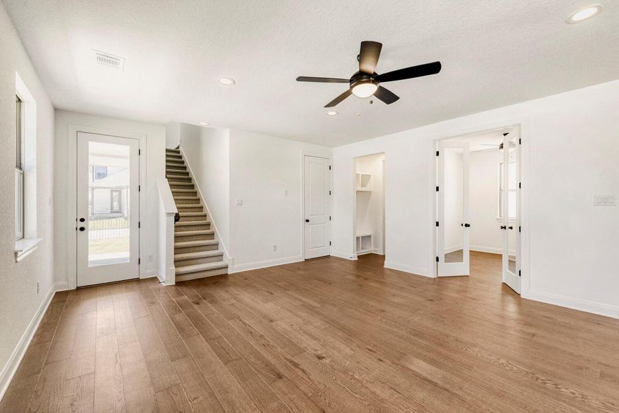 Unfurnished living room featuring recessed lighting, dark wood-style floors, and a ceiling fan Unfurnished living room featuring recessed lighting, dark wood-style floors, and a ceiling fan
