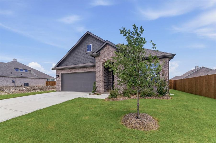 Brick and shingle-sided exterior with a prominent two-car garage Brick and shingle-sided exterior with a prominent two-car garage
