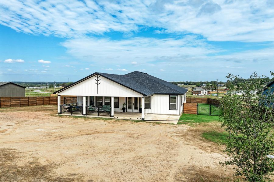 A spacious covered patio anchors the rear of this contemporary board-and-batten home. A spacious covered patio anchors the rear of this contemporary board-and-batten home.
